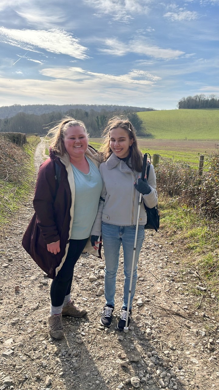 Photograph showing two blatchington court trust clients standing on a country path in front of hills