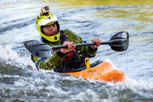Photograph of man kayaking