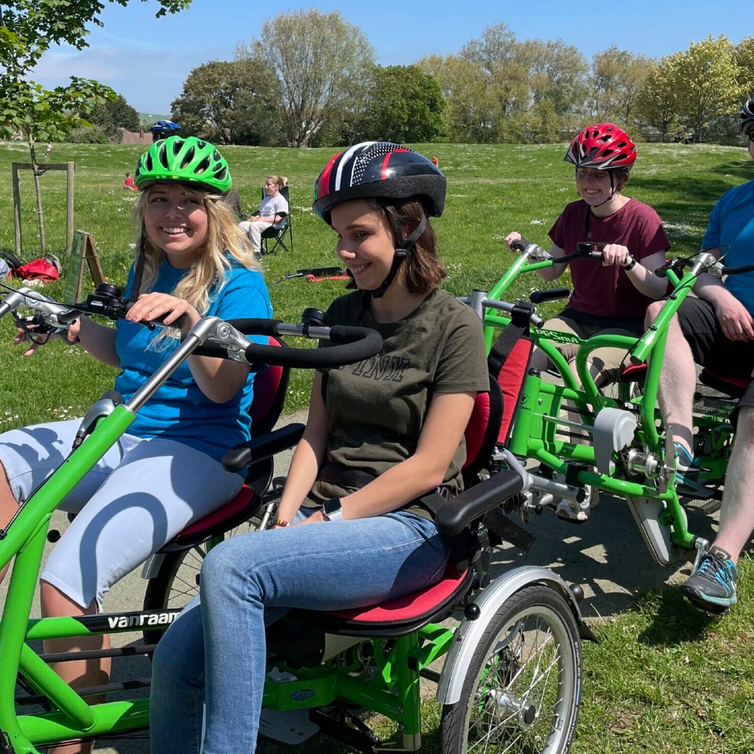 photograph of person cycling on an adapted bicycle